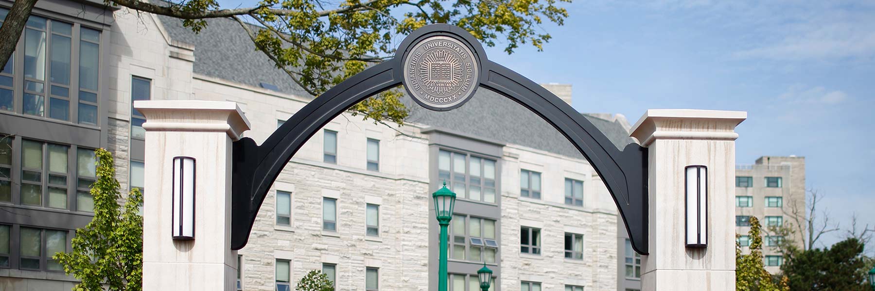 The Indiana University seal on an arched gateway.
